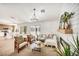 Bright living room with modern chandelier, fireplace, and views to the backyard at 3009 Anna Bay Dr, Las Vegas, NV 89134