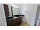 Modern bathroom features a sleek black countertop and stylish dark brown cabinetry at 3020 Wilmington Way, Las Vegas, NV 89102