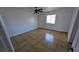 An empty bedroom has tile floors, a ceiling fan and a window for natural light at 3020 Wilmington Way, Las Vegas, NV 89102