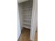 Linen closet with bright white shelving provides ample storage, complemented by neutral tile flooring at 3020 Wilmington Way, Las Vegas, NV 89102