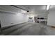 Spacious two car garage with white walls and ceiling and laundry hookups offers lots of potential and storage at 3020 Wilmington Way, Las Vegas, NV 89102