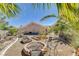 Desert landscaped backyard featuring a fire pit and plenty of space for outdoor activities at 3112 Haddon Dr, Las Vegas, NV 89134