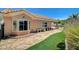 Backyard with stone pathway, artificial grass, and a well-maintained exterior at 3112 Haddon Dr, Las Vegas, NV 89134