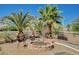 Outdoor seating area with a fire pit and mature palm trees, perfect for relaxing at 3112 Haddon Dr, Las Vegas, NV 89134