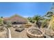 Backyard featuring desert landscaping, a fire pit, and a glimpse of the mountain range at 3112 Haddon Dr, Las Vegas, NV 89134