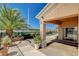 Covered patio with lush landscaping, potted plants, and a glimpse of the pool at 3112 Haddon Dr, Las Vegas, NV 89134
