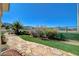 Scenic backyard featuring a stone path, artificial grass, and well-manicured landscaping at 3112 Haddon Dr, Las Vegas, NV 89134