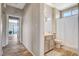 Hallway view into a bathroom with a white shower curtain and tile flooring at 3112 Haddon Dr, Las Vegas, NV 89134