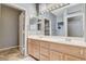 Bathroom featuring a dual sink vanity, ample lighting and mirror with views to a closet and powder room at 3112 Haddon Dr, Las Vegas, NV 89134