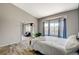 Bright bedroom features a window bay, wood-look floors, a glimpse of a sitting room, and modern decor at 3112 Haddon Dr, Las Vegas, NV 89134