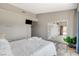Airy bedroom provides access to enclosed patio and features a mounted TV and wood-look floors at 3112 Haddon Dr, Las Vegas, NV 89134