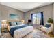 Cozy bedroom featuring a queen-sized bed, wicker furniture, and a picturesque window view with a TV at 3112 Haddon Dr, Las Vegas, NV 89134
