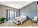 Cozy bedroom featuring an accent wall, bay window, wood-look tile flooring, and neutral furnishings at 3112 Haddon Dr, Las Vegas, NV 89134