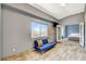 Bonus room showcasing a blue couch, window, and double doors to a bedroom at 3112 Haddon Dr, Las Vegas, NV 89134