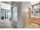 Hallway leads into a bedroom and bathroom, showcasing the home's modern layout and wood-look tile flooring at 3112 Haddon Dr, Las Vegas, NV 89134