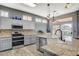 Bright kitchen features stainless steel appliances, granite countertops and a stylish center island with a sink at 3112 Haddon Dr, Las Vegas, NV 89134