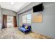 Bright living room featuring a blue couch, mounted TV, and sliding doors to the pool area at 3112 Haddon Dr, Las Vegas, NV 89134