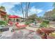 Lush backyard offers mature trees, outdoor seating, fountain, and lounge chairs for leisure at 3158 La Luna Cir, Henderson, NV 89014