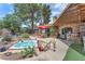 Relaxing backyard oasis with a hot tub, mature trees, and patio space for outdoor enjoyment at 3158 La Luna Cir, Henderson, NV 89014