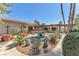 An outdoor entertaining space with lounge chairs, patio furniture, and a tiered fountain at 3158 La Luna Cir, Henderson, NV 89014