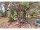Backyard garden area featuring a metal gazebo surrounded by greenery, providing a peaceful retreat at 3158 La Luna Cir, Henderson, NV 89014