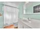 A standard bathroom with a white sink, toilet, shower curtain, and medicine cabinet at 3158 La Luna Cir, Henderson, NV 89014