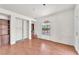 Unfurnished bedroom with wood floors, a built-in bookshelf, arched window, and a closet at 3158 La Luna Cir, Henderson, NV 89014