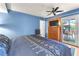Relaxing bedroom featuring a large bed, backyard access, and natural lighting at 3158 La Luna Cir, Henderson, NV 89014