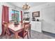 View of chandelier-lit dining table near a window, featuring built in and matching chairs at 3158 La Luna Cir, Henderson, NV 89014