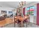 Dining area with a wooden table, stone wall, and view to the backyard at 3158 La Luna Cir, Henderson, NV 89014