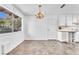 Dining room with large window, chandelier lighting, and linoleum flooring at 3158 La Luna Cir, Henderson, NV 89014