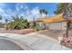 Eye-level view of a single-story house with a terracotta roof, desert landscaping, and an attached garage at 3158 La Luna Cir, Henderson, NV 89014