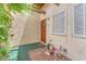 Close up of front door, welcome mat, wooden door and sidelight, plants and muted paint at 3158 La Luna Cir, Henderson, NV 89014