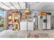 Spacious garage with washer, dryer, refrigerator, shelving, and storage cabinets at 3158 La Luna Cir, Henderson, NV 89014