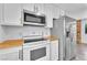 Kitchen featuring stainless appliances, laminate countertops, and white cabinetry at 3158 La Luna Cir, Henderson, NV 89014