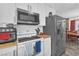 Kitchen with stainless steel appliances and white cabinetry, adjacent dining area at 3158 La Luna Cir, Henderson, NV 89014
