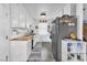 Galley kitchen features white cabinetry, butcher block countertops, stainless appliances at 3158 La Luna Cir, Henderson, NV 89014