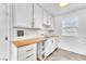 Galley kitchen with white cabinets, laminate countertops, and tiled backsplash at 3158 La Luna Cir, Henderson, NV 89014