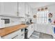 Bright kitchen features white cabinetry, butcher block countertops, and stainless steel sink at 3158 La Luna Cir, Henderson, NV 89014