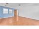 An empty living room with light blue accent wall, hardwood floors and front door at 3158 La Luna Cir, Henderson, NV 89014