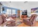 Comfortable living room featuring hardwood floors, couches, and a flatscreen television at 3158 La Luna Cir, Henderson, NV 89014