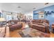 Spacious living room boasts a stone fireplace, comfortable seating, and open access to the dining area at 3158 La Luna Cir, Henderson, NV 89014