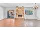 Spacious living room features a stone fireplace, wood floors, and sliding glass doors to the backyard at 3158 La Luna Cir, Henderson, NV 89014