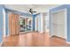 Bright bedroom with blue walls, hardwood floors, closet, and sliding glass door access to backyard at 3158 La Luna Cir, Henderson, NV 89014