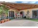 Covered patio with an outdoor dining set and views of the backyard landscaping at 3158 La Luna Cir, Henderson, NV 89014