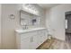 A bathroom features a large mirror, a vanity with white cabinets, and a toilet at 3400 Cabana Dr # 1048, Las Vegas, NV 89122