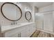 Modern bathroom features a dual sink vanity and a glass-enclosed shower with white tile surround at 3400 Cabana Dr # 1048, Las Vegas, NV 89122