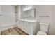 Well-lit bathroom showcasing a tub with shower, white vanity, and toilet at 3400 Cabana Dr # 1048, Las Vegas, NV 89122