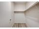 Walk-in closet featuring laminate floors and shelf with hanging rod at 3400 Cabana Dr # 1048, Las Vegas, NV 89122