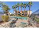 Relaxing community pool with lounge chairs and swaying palm trees on a sunny day at 3400 Cabana Dr # 1048, Las Vegas, NV 89122